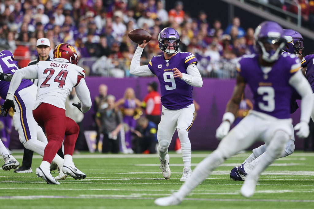 Minnesota Vikings quarterback J.J. McCarthy (9) passes the ball during the first half of an NFL football game against the Washington Commanders, Sunday, Dec. 7, 2025, in Minneapolis. (AP Photo/Matt Krohn)
