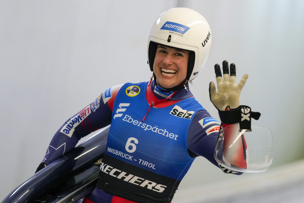 FILE - Emily Sweeney of the United States waves after the women's sprint race at the Luge World Cup in Igls near Innsbruck, Austria, Dec. 7, 2024. (AP Photo/Matthias Schrader, File)