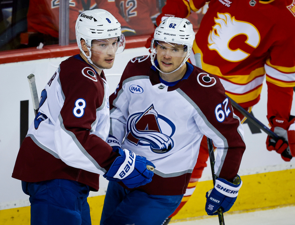 Colorado Avalanche's Cale Makar (8) celebrates after his goal with teammate Artturi Lehkonen (62) during the second period of an NHL hockey game against the Calgary Flames in Calgary, Alberta, Thursday, Oct. 8, 2026. (Jeff McIntosh/The Canadian Press via AP)