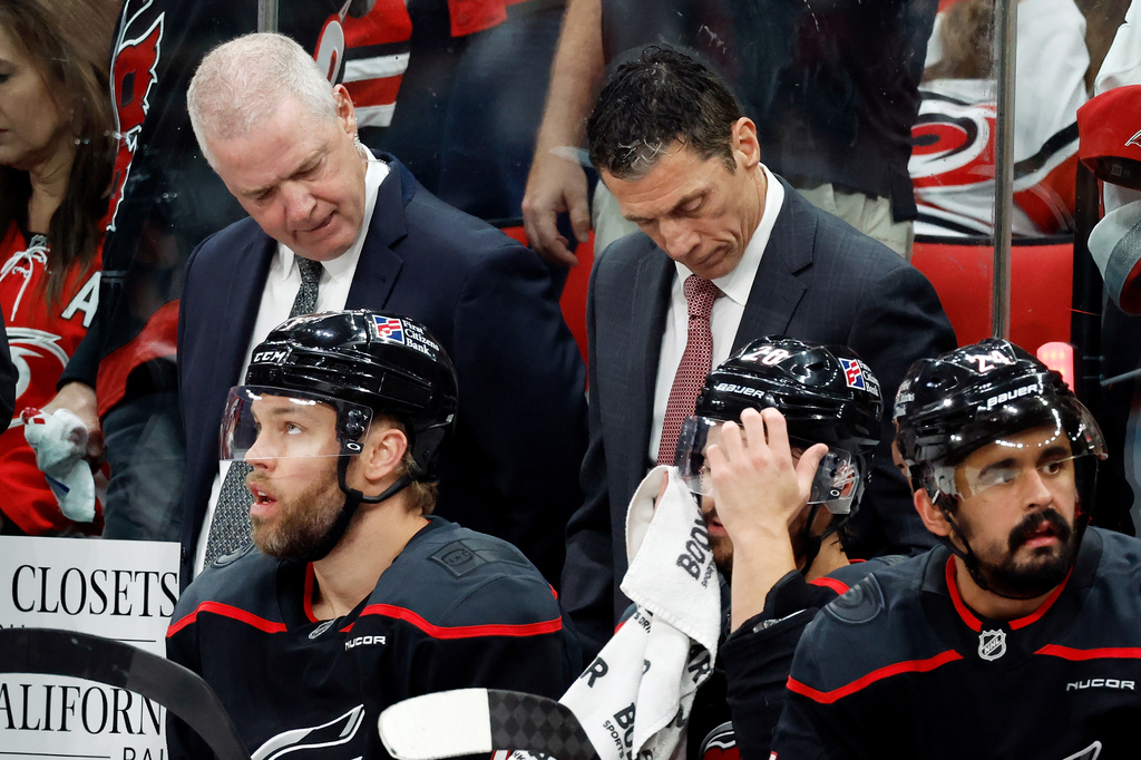 Carolina Hurricanes head coach Rod Brind'Amour, top right, looks at a replay during the first period in Game 5 of the Eastern Conference finals NHL hockey Stanley Cup playoff series against the Montreal Canadiens in Raleigh, N.C., Friday, May 29, 2026. (AP Photo/Karl DeBlaker)