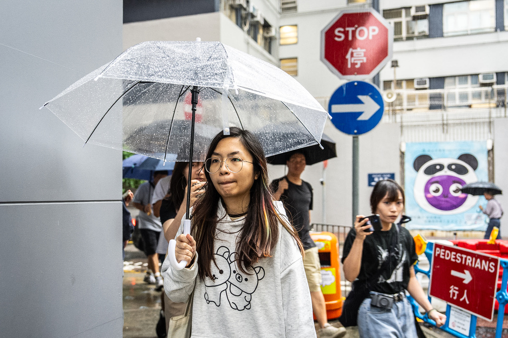 Mandy Lau, a bookseller of Have A Nice Stay bookstore, who was earlier arrested by the police, leaves a police station in Cheung Sha Wan, Hong Kong, Friday, July 17, 2026. (AP Photo/Chan Long Hei)
