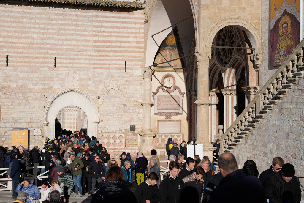 Pilgrims leave after they honored the bones of St. Francis during the first public display inside the St. Francis Basilica, marking the 800th anniversary of the saint's death, in Assisi, Italy, Sunday, Feb. 22, 2026.(AP Photo/Gregorio Borgia)