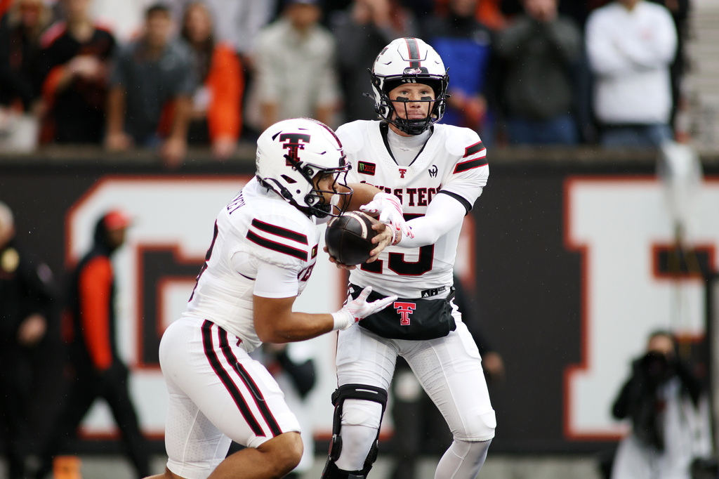 Texas Tech quarterback Will Hammond (15) hands off the ball to running back Cameron Dickey (8) during the first half of an NCAA college football game against Oregon State, Saturday, Sept. 12, 2026, in Corvallis, Ore. (AP Photo/Lydia Ely)