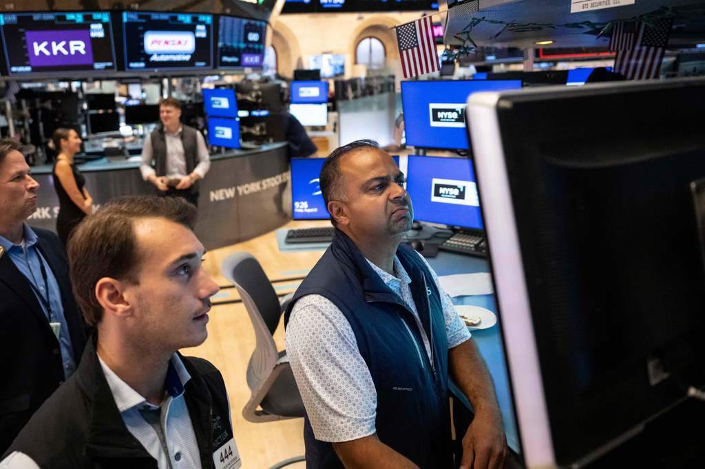 Specialists Dilip Patel, right, and Dylan Halvorsen work on the floor of the New York Stock Exchange in New York, Friday, Aug. 21, 2026. (AP Photo/Yuki Iwamura)