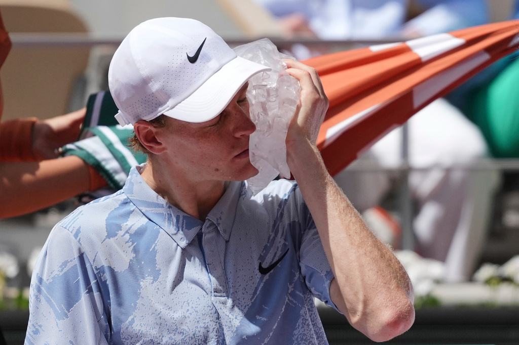 Jannik Sinner of Italy cools himself with the ice during the second round men's singles tennis match against Juan Manuel Cerundolo of Argentina at the French Open tennis tournament in Paris, Thursday, May 28, 2026. (AP Photo/Thibault Camus)