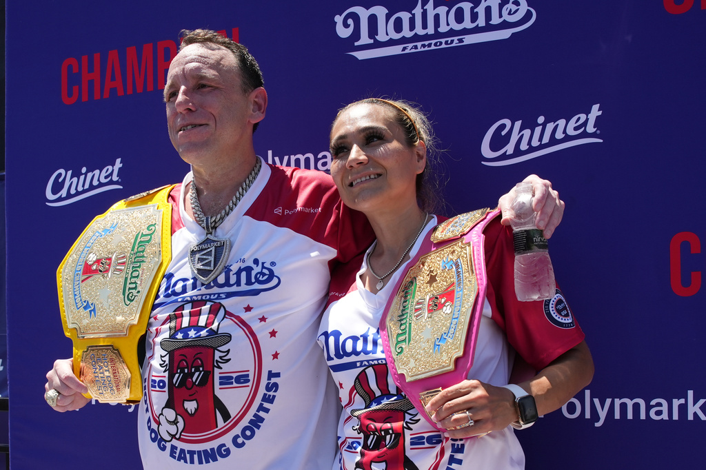 Joey Chestnut and Miki Sudo, winners of the 2026 Nathan's Famous Fourth of July hot dog eating contest, hold their title belts at Coney Island in the Brooklyn borough of New York, Saturday, July 4, 2026. (AP Photo/Anna Connors)