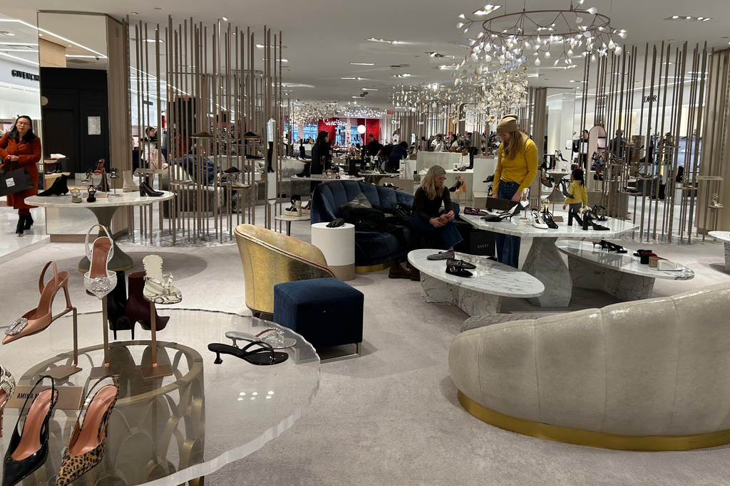 Shoppers look at merchandise at Saks Fifth Avenue on Friday, Jan. 16, 2026 in New York. (AP Photo/Anne D'Innocenzio)