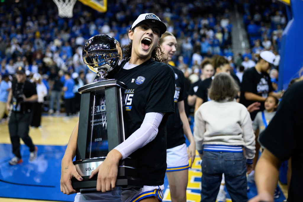 UCLA center Lauren Betts carries the Big Ten trophy after an NCAA college basketball game against Wisconsin, Sunday, Feb. 22, 2026, in Los Angeles. (AP Photo/William Liang)
