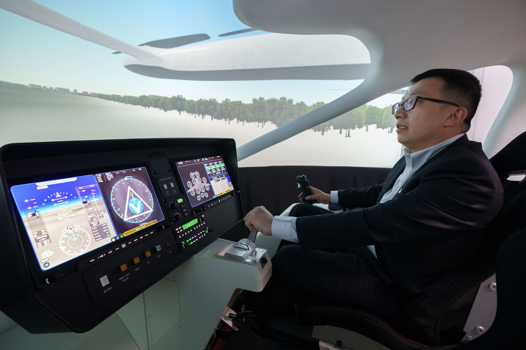 Steven Yang, senior vice president of AutoFlight, demonstrates at a flying simulation of its company eVTOL aircraft in Shanghai, China, on Feb. 24, 2026. (AP Photo/Vincent Thian)