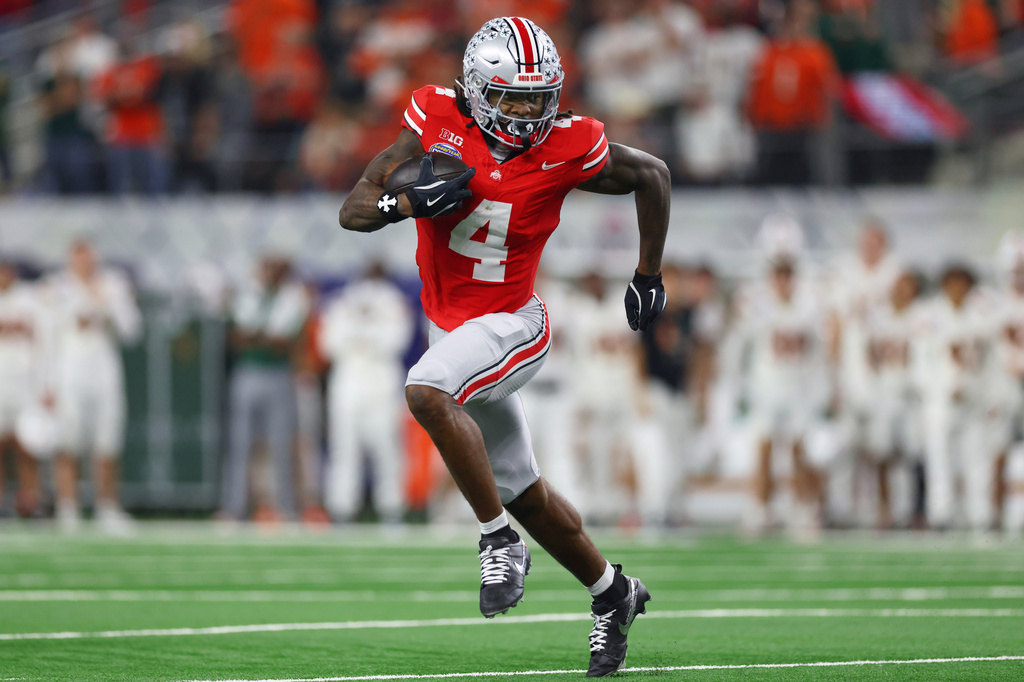 FILE - Ohio State wide receiver Jeremiah Smith runs the ball against Miami during the second half of the Cotton Bowl College Football Playoff quarterfinal game, Dec. 31, 2025, in Arlington, Texas. (AP Photo/Gareth Patterson, File)