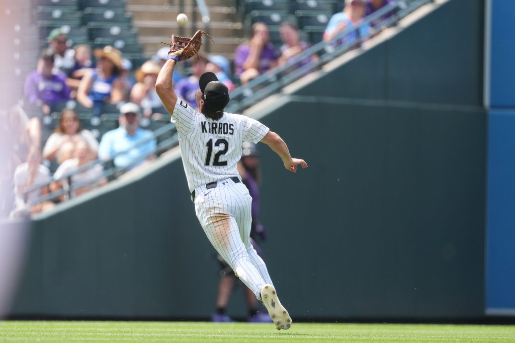 Colorado Rockies third baseman Kyle Karros pulls in a pop fly off the bat of Miami Marlins' Joe Mack in the sixth inning of a baseball game Thursday, July 2, 2026, in Denver. (AP Photo/David Zalubowski)