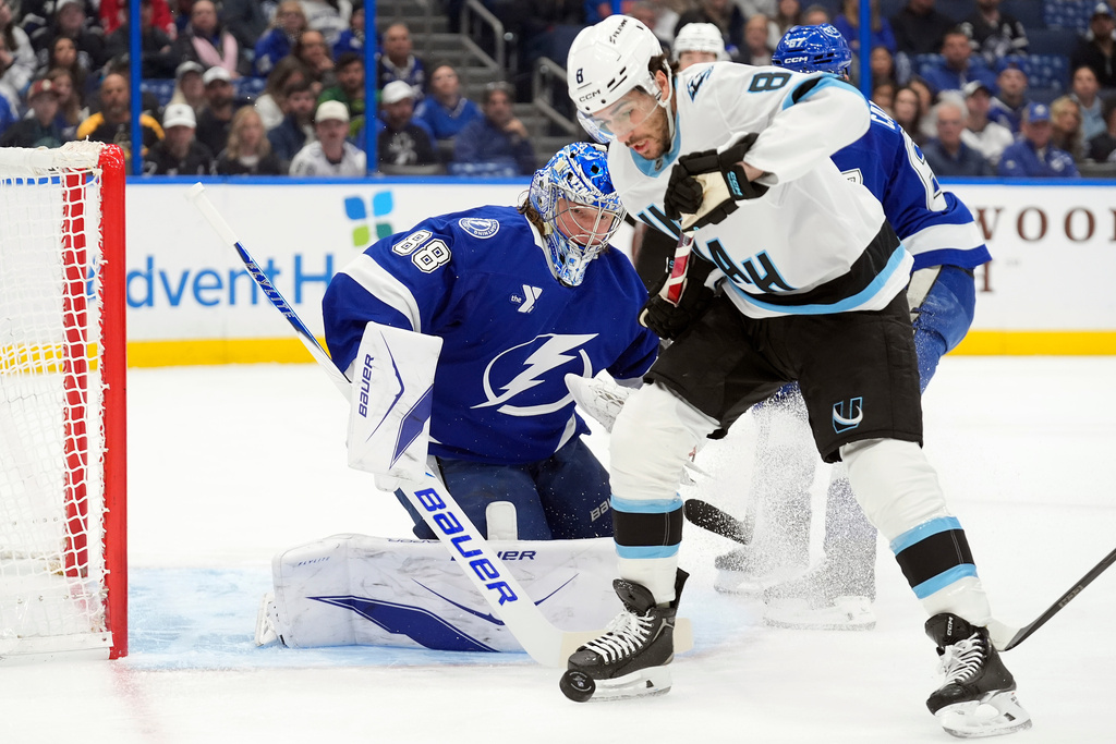 Tampa Bay Lightning goaltender Andrei Vasilevskiy (88) stops a shot by Utah Mammoth center Nick Schmaltz (8) during the first period of an NHL hockey game Monday, Jan. 26, 2026, in Tampa, Fla. (AP Photo/Chris O'Meara)