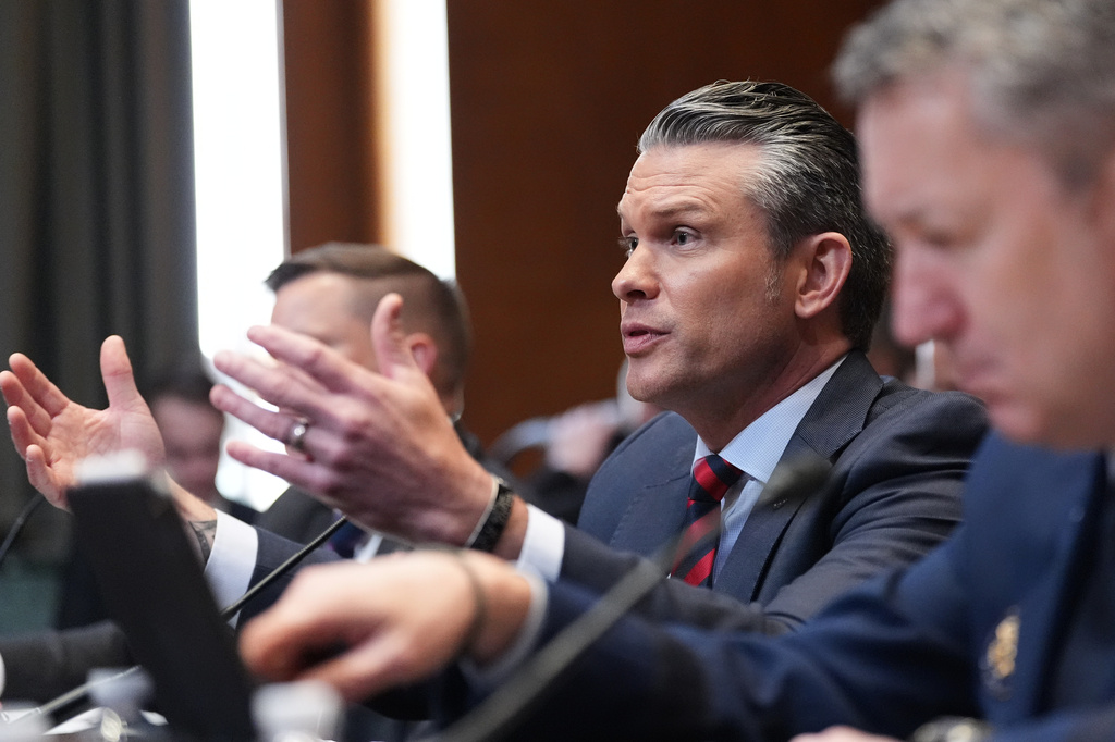 Defense Secretary Pete Hegseth testifies at a Senate Appropriations subcommittee on defense hearing on the budget request for the Department of Defense, Tuesday, May 12, 2026, in Washington, with acting Under Secretary of Defense and Comptroller Jules Hurst III, left, and Chairman of the Joint Chiefs of Staff Gen. Dan Caine. (AP Photo/Alex Brandon)