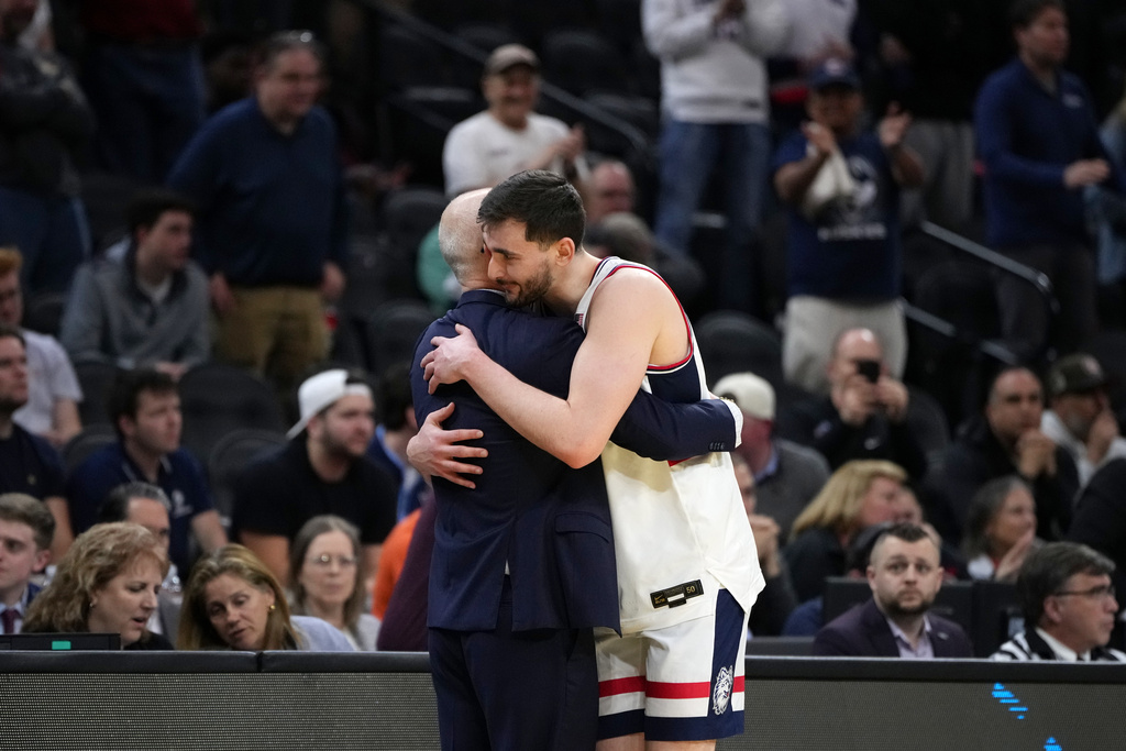 UConn's Alex Karaban, right, hugs coach Dan Hurley during the second half against UCLA in the second round of the NCAA college basketball tournament, Sunday, March 22, 2026, in Philadelphia. (AP Photo/Matt Slocum)