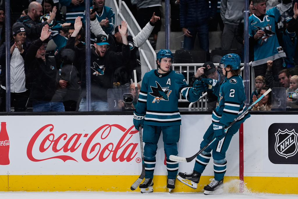 San Jose Sharks center Macklin Celebrini (71) celebrates with center Will Smith (2) after scoring a goal during the first period of an NHL hockey game against the Florida Panthers, Saturday, Nov. 8, 2025, in San Jose, Calif. (AP Photo/Godofredo A. Vásquez)