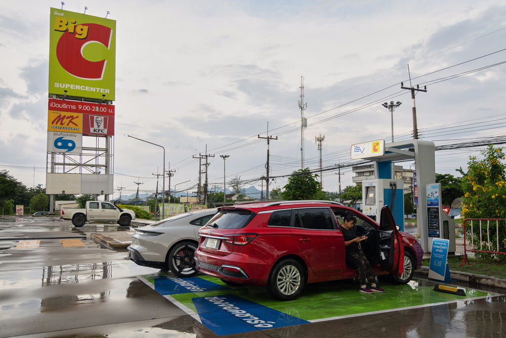 Chanakan Sa-Nguanslip waits for her Chinese-made electric vehicle to charge at a gas station in Kanchanaburi, Thailand on May 30, 2026. (AP Photo/Anton L. Delgado)