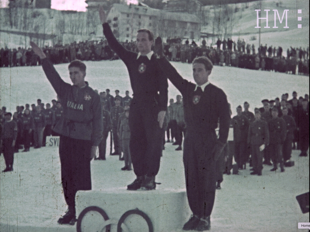 Gold-medalist Josef Jennewein of Germany, center, silver-medalist Alberto Marcellin of Italy, left, and bronze-medalist Rudolf Cranz of Germany perform a fascist salute on the podium during the 1941 Alpine Ski World Ski Championships, in Cortina D'Ampezzo, Italy. (Fondazione Home Movies – Archivio Nazionale del Film di Famiglia via AP)