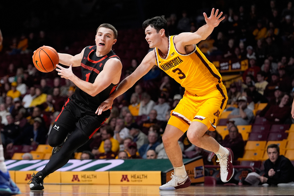 Gardner-Webb guard Spence Sims (1) works toward the basket as Minnesota forward Bobby Durkin (3) defends during the second half of an NCAA college basketball game Monday, Nov. 3, 2025, in Minneapolis. (AP Photo/Abbie Parr)