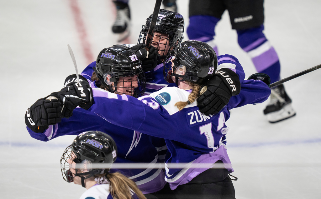 FILE - Minnesota Frost forward Taylor Heise (27), is surrounded by teammates, forwards Britta Curl (77) and Grace Zumwinkle (13), after she scored the winning goal in overtime of the PWHL Walter Cup hockey game in St. Paul, Minn., May 14, 2025. (Renée Jones Schneider/Star Tribune via AP, File)