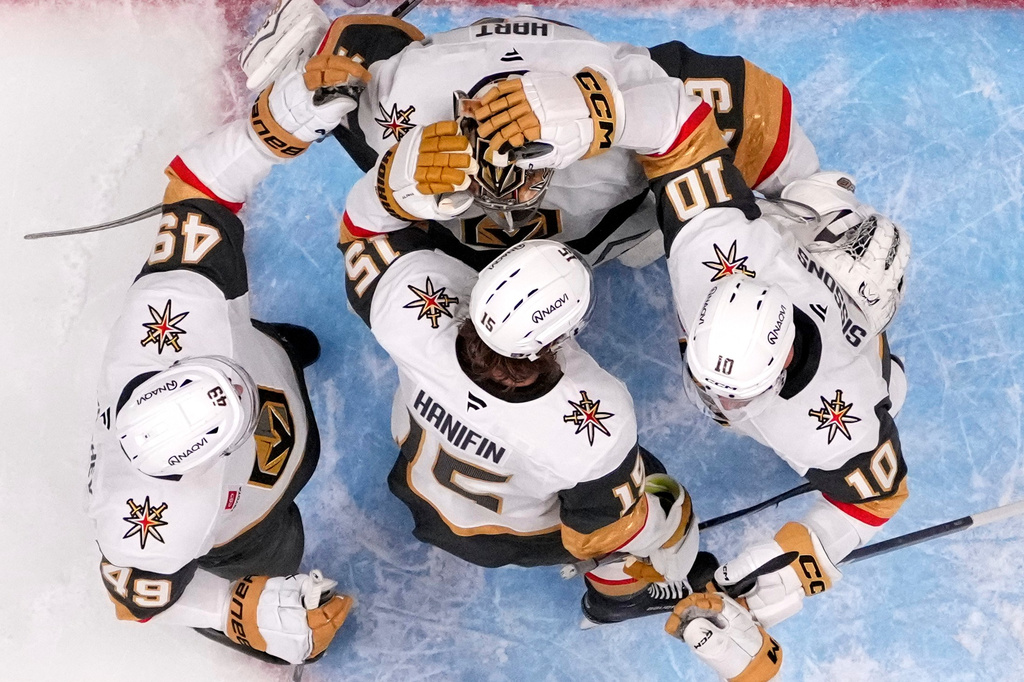 Vegas Golden Knights goaltender Carter Hart, top, is congratulated by teammates after the Golden Knights defeated the Anaheim Ducks in Game 6 of a second-round NHL hockey Stanley Cup playoff series Thursday, May 14, 2026, in Anaheim, Calif. (AP Photo/Mark J. Terrill)
