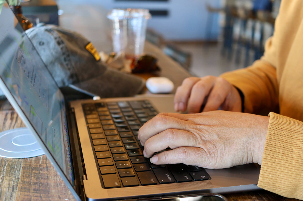 Lauren Contreras, 40, works from her laptop at Foxtail Coffee Co., in Flagstaff, Ariz., on Monday, April 20, 2026. (AP Photo/Cheyanne Mumphrey)