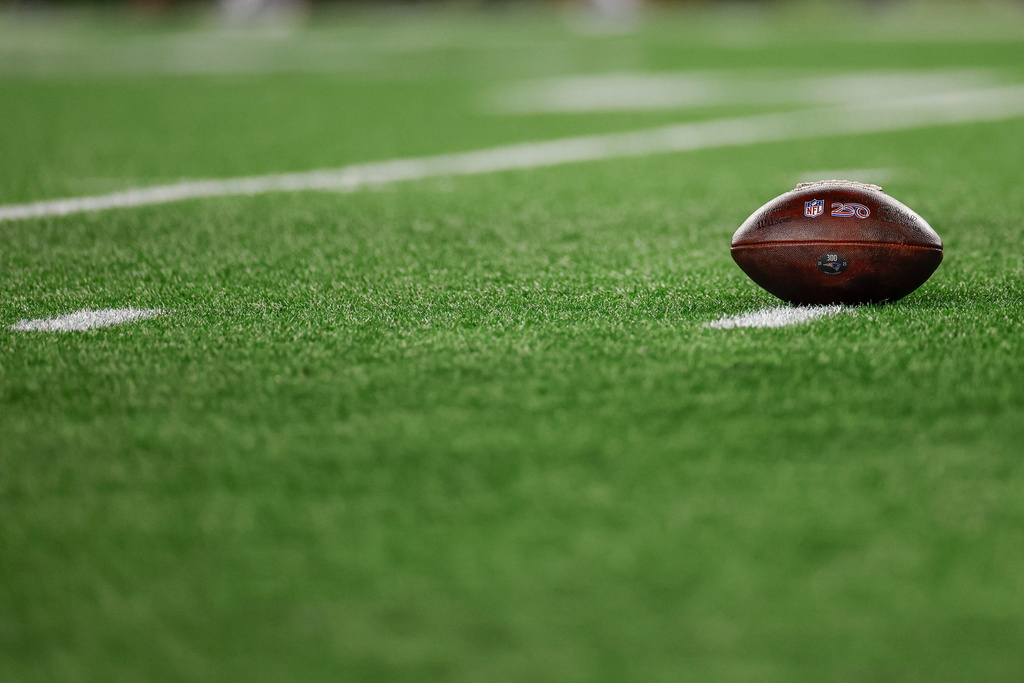 FILE - A football with the NFL shield logo rests on the turf during the second half of an NFL wild card playoff football game between the New England Patriots and the Los Angeles Chargers, Jan. 11, 2026, in Foxborough, Mass. (AP Photo/Greg M. Cooper, File)