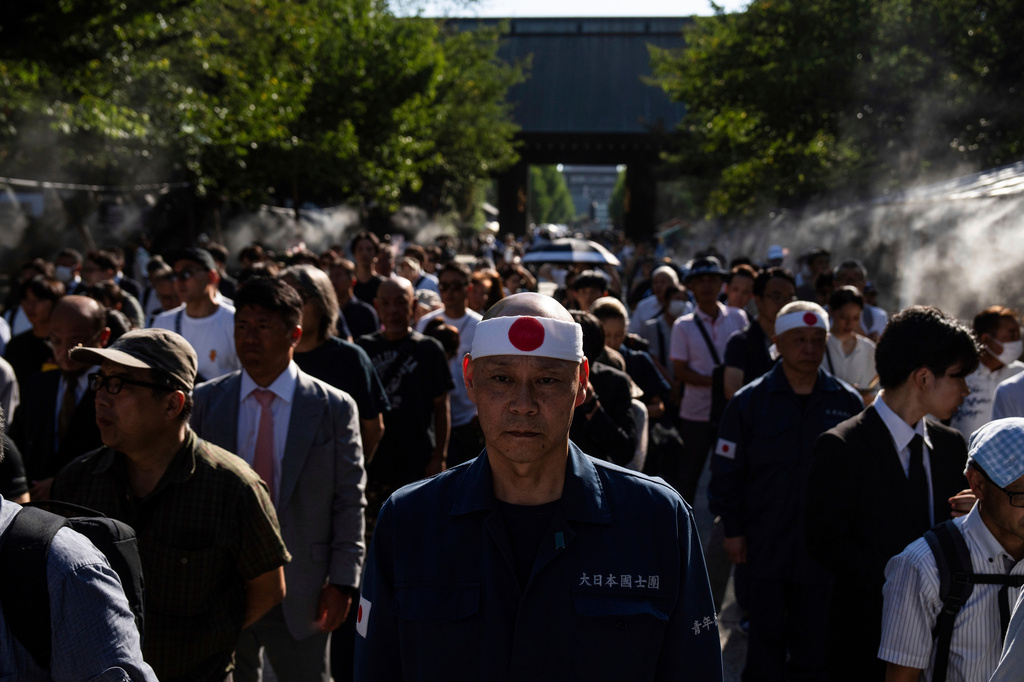 FILE - Visitors line up to offer prayers at the Yasukuni Shrine on the 80th anniversary of Japan's surrender in World War II in Tokyo, Aug. 15, 2025. (AP Photo/Louise Delmotte, File)