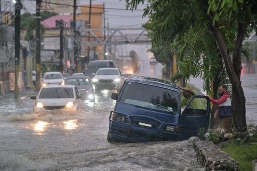 People abandon a car on an impassable street flooded by rains caused by Tropical Storm Melissa in Santo Domingo, Dominican Republic, Friday, Oct. 24, 2025. (AP Photo/Ricardo Hernandez) People abandon a car on an impassable street flooded by rains caused by Tropical Storm Melissa in Santo Domingo, Dominican Republic, Friday, Oct. 24, 2025. (AP Photo/Ricardo Hernandez)
