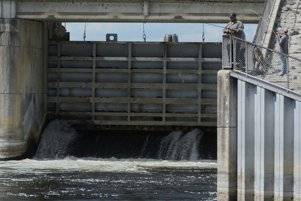 Fisherman throw their lines into the Kirkpatrick Dam spillway Wednesday, March 4, 2026, in Palatka, Fla. (AP Photo/Marta Lavandier)