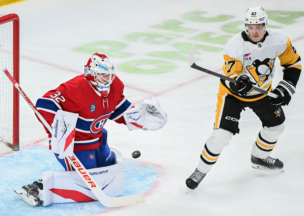 Pittsburgh Penguins' Rickard Rakell (67) moves in on Montreal Canadiens goaltender Jacob Fowler (32) during the second period of an NHL hockey game, in Montreal, Saturday, Dec. 20, 2025. (Graham Hughes/The Canadian Press via AP)