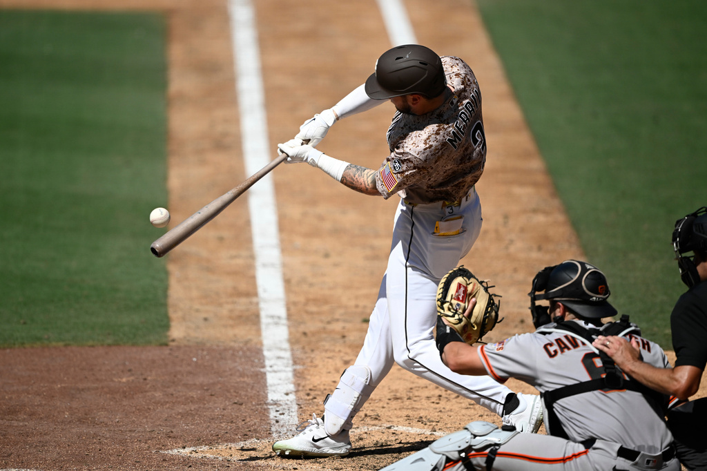 San Diego Padres' Jackson Merrill hits a single during the seventh inning of a baseball game against the San Francisco Giants, Sunday, Aug. 2, 2026, in San Diego. (AP Photo/Denis Poroy)