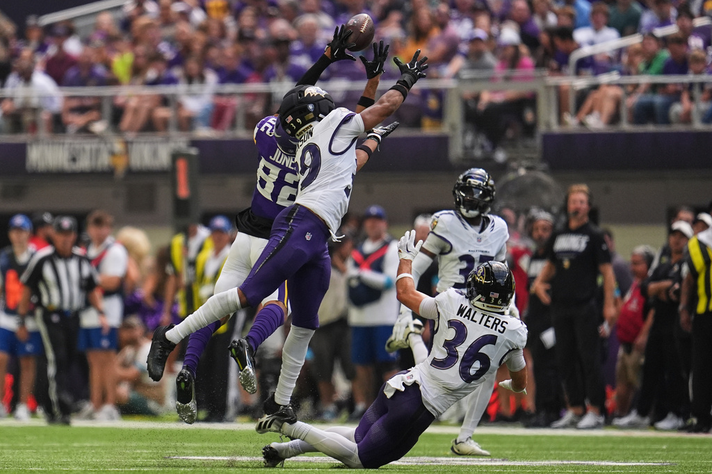 Minnesota Vikings wide receiver Jeshaun Jones (82) catches a 35-yard pass against Baltimore Ravens safety Keondre Jackson, second from left, during the first half of an NFL preseason football game, Saturday, Aug. 22, 2026, in Minneapolis. (AP Photo/Abbie Parr)