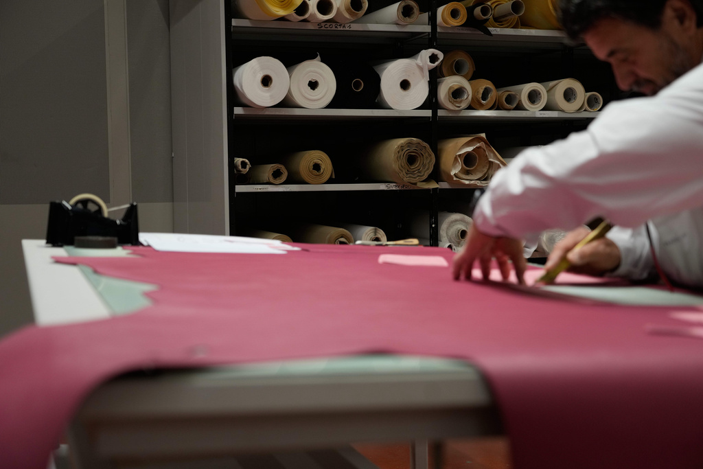 A leather good operator works at the Prada factory in Scandicci, Italy, Friday, Nov. 28, 2025. (AP Photo/Gregorio Borgia)