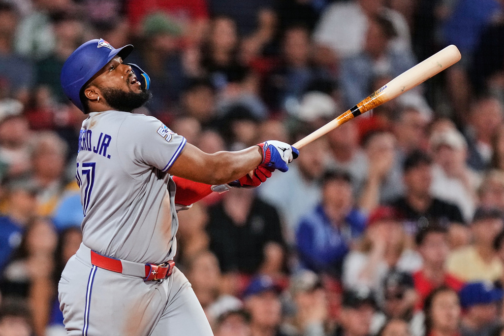 Toronto Blue Jays' Vladimir Guerrero Jr. watches the flight of his RBI single during the eighth inning of a baseball game against the Boston Red Sox, Wednesday, June 17, 2026, in Boston. (AP Photo/Charles Krupa)