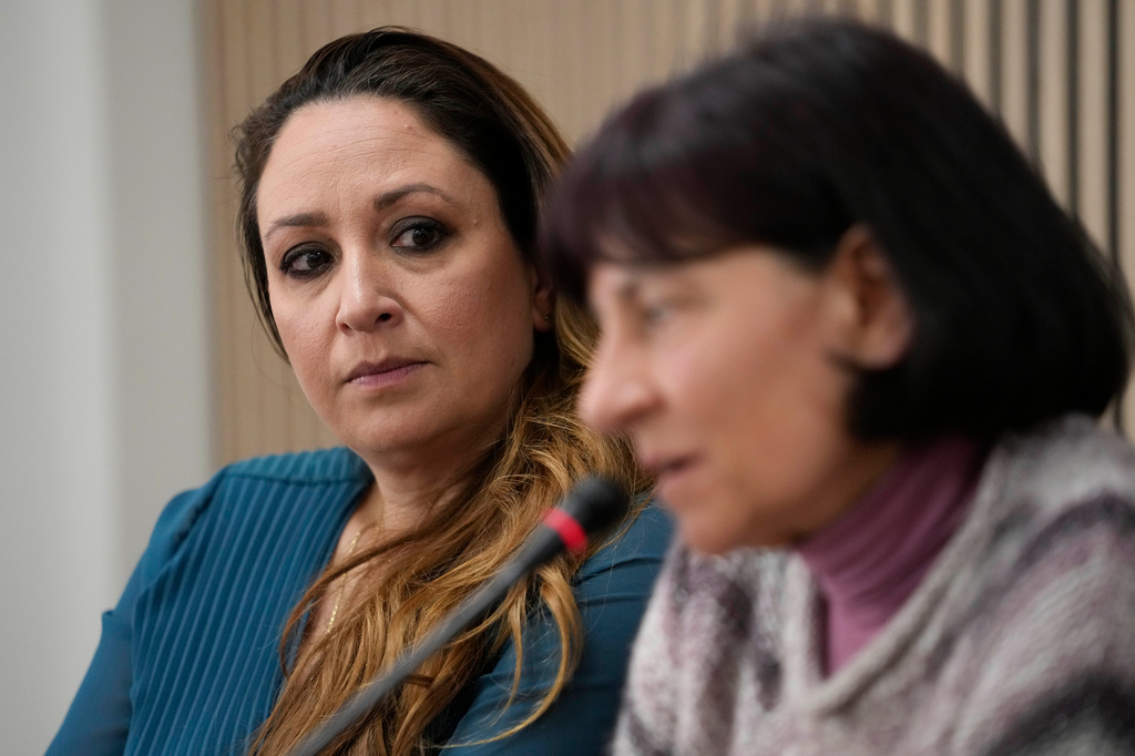 FILE - Lawyer Laura Sgro, left, listens to Gloria Branciani during a press conference in Rome, Feb. 21, 2024. (AP Photo/Alessandra Tarantino, File)