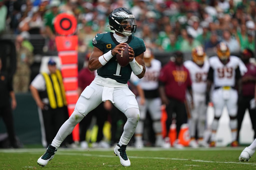 Philadelphia Eagles quarterback Jalen Hurts (1) looks to pass against the Washington Commanders during the first half of an NFL football game, Sunday, Sept. 13, 2026, in Philadelphia. (AP Photo/Matt Rourke)