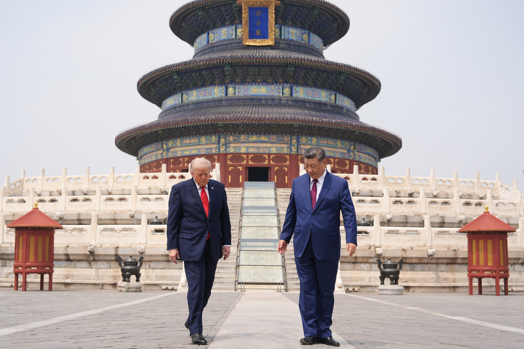 President Donald Trump, left, walks with Chinese President Xi Jinping at the Temple of Heaven on Thursday May 14, 2026, in Beijing. (AP Photo/Mark Schiefelbein)