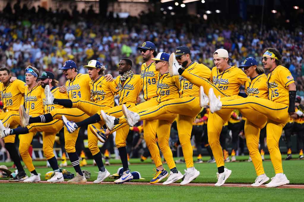 FILE - The Savannah Bananas do a kick line before their game against the Firefighters during their "Banana Ball World Tour," Sept. 19, 2025, in Seattle. (AP Photo/Lindsey Wasson, File)