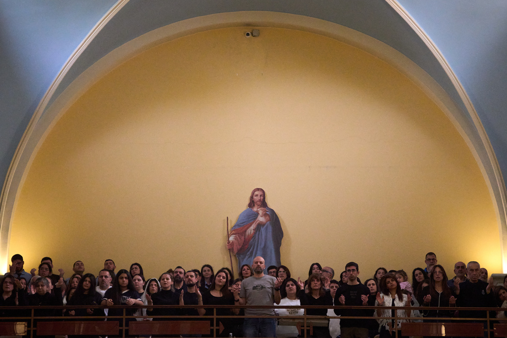 Worshipers pray during Good Friday Mass at St. Anthony Church, which was devoted to expressing solidarity with Christian villagers in southern Lebanon displaced by the war in Jdeideh, a suburb of Beirut, Lebanon, Friday, April 3, 2026. (AP Photo/Emilio Morenatti)