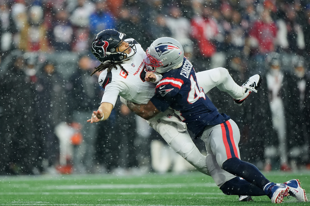 New England Patriots linebacker K'lavon Chaisson, right, hits Houston Texans quarterback C.J. Stroud during the first half of an NFL divisional playoff football game, Sunday, Jan. 18, 2026, in Foxborough, Mass. (AP Photo/Robert F. Bukaty)