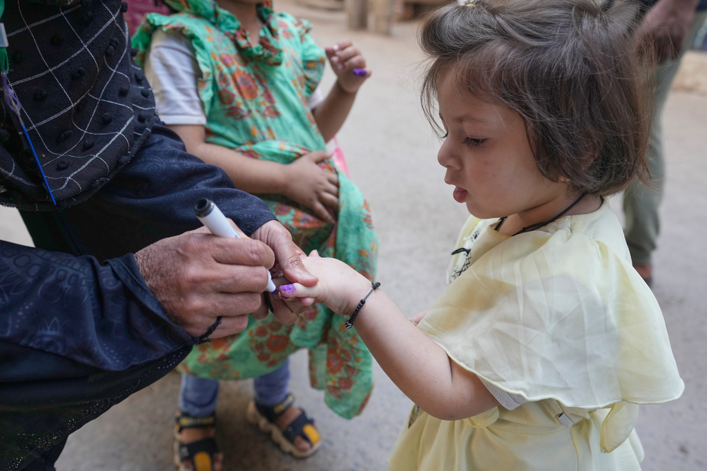 A health worker marks a child's finger after administering a polio vaccine in Lahore, in Lahore, Pakistan, Monday, April 13, 2026. (AP Photo/K.M. Chaudary)