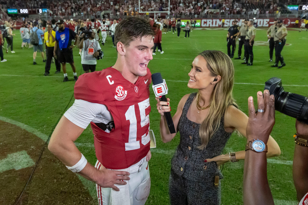 Alabama quarterback Ty Simpson (15) talks with ESPN's Molly McGrath, right, after his team's win over Tennessee in an NCAA college football game, Saturday, Oct. 18, 2025, in Tuscaloosa, Ala. (AP Photo/Vasha Hunt)