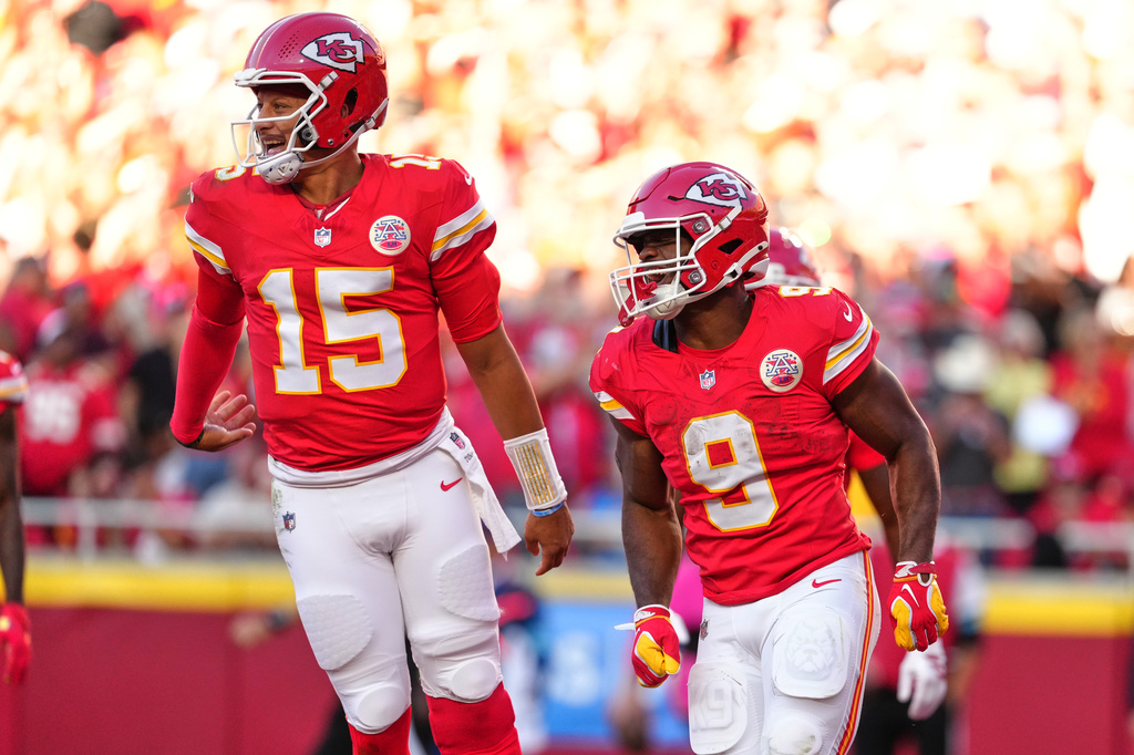 Kansas City Chiefs quarterback Patrick Mahomes (15) and Kenneth Walker III (9) celebrate a touchdown scored on a rushing play by Walker III during the first half of an NFL football game against the Los Angeles Chargers in Kansas City, Mo., Sunday, Oct. 18, 2026. (AP Photo/Ed Zurga)