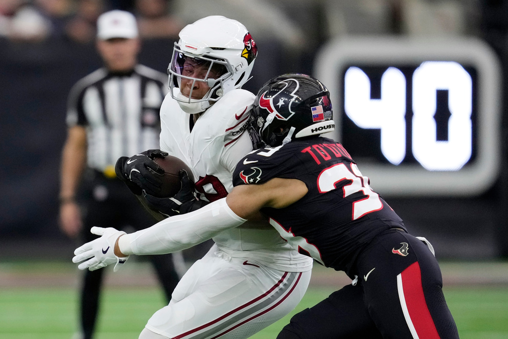 Houston Texans linebacker Henry To'Oto'O, right, tackles Arizona Cardinals tight end Pharaoh Brown during the first half of an NFL football game Sunday, Dec. 14, 2025, in Houston. (AP Photo/Ashley Landis)