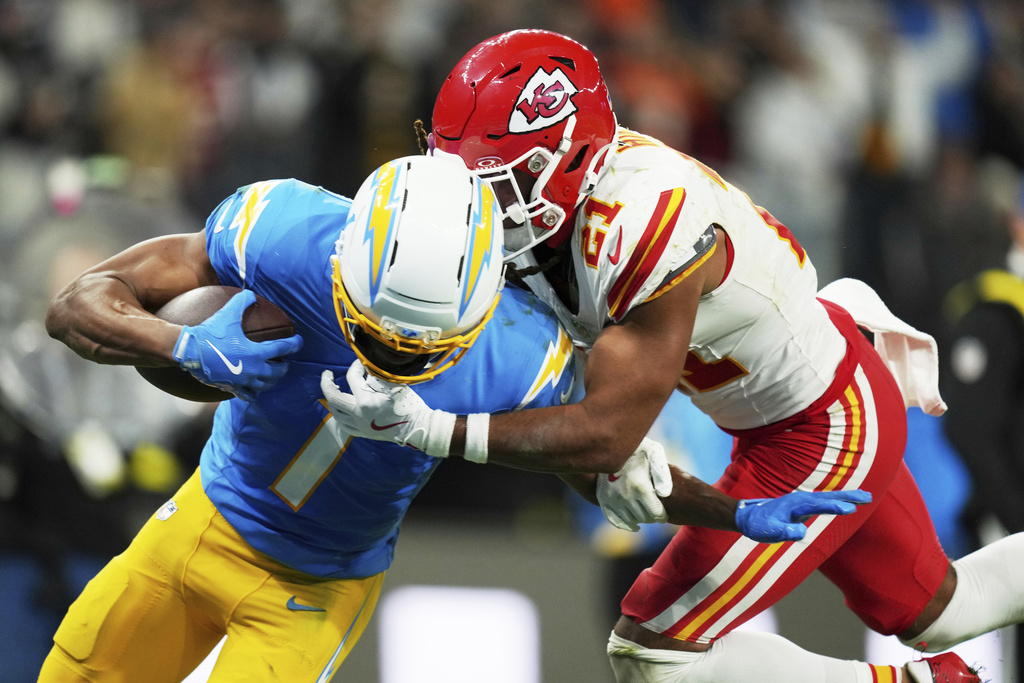 Los Angeles Chargers wide receiver Quentin Johnston scores past Kansas City Chiefs safety Jaden Hicks during the second half of an NFL football game, Friday, Sept. 5, 2025, in Sao Paulo. (AP Photo/Andre Penner)