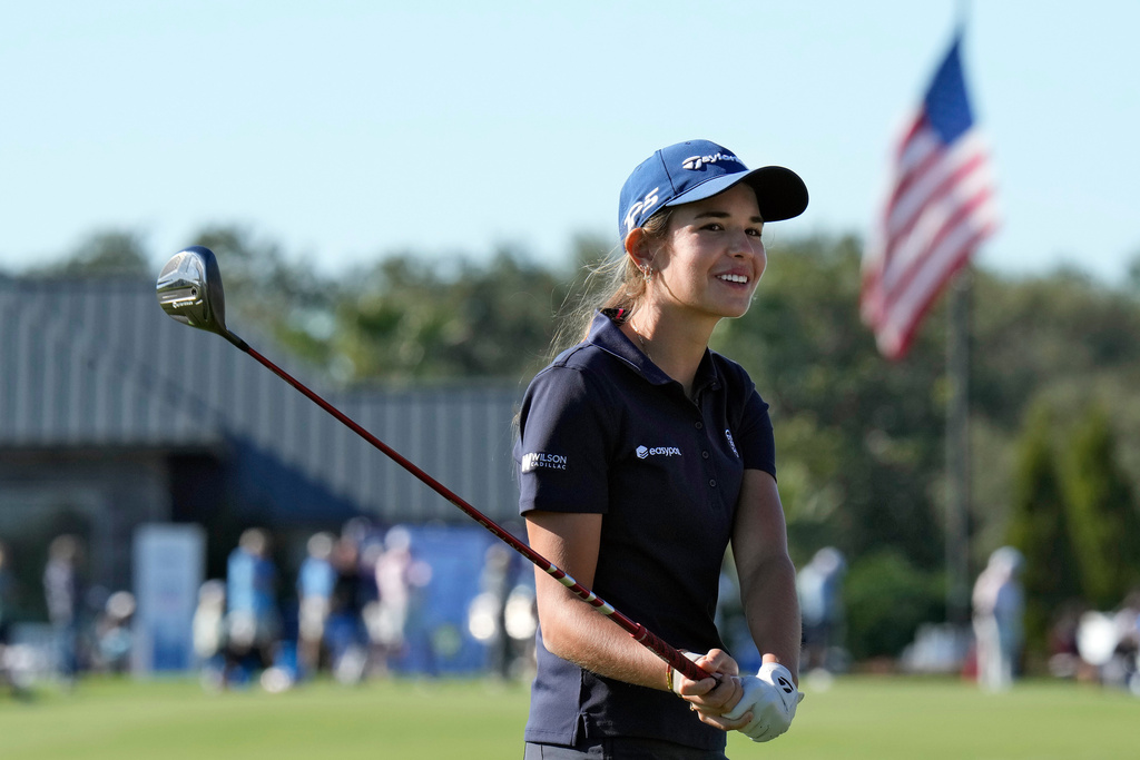 Kai Trump, granddaughter of President Donald Trump, smiles as she waits to hit from the 18th fairway during the first round of The Annika LPGA golf tournament Thursday, Nov. 13, 2025, in Belleair, Fla. (AP Photo/Chris O'Meara)