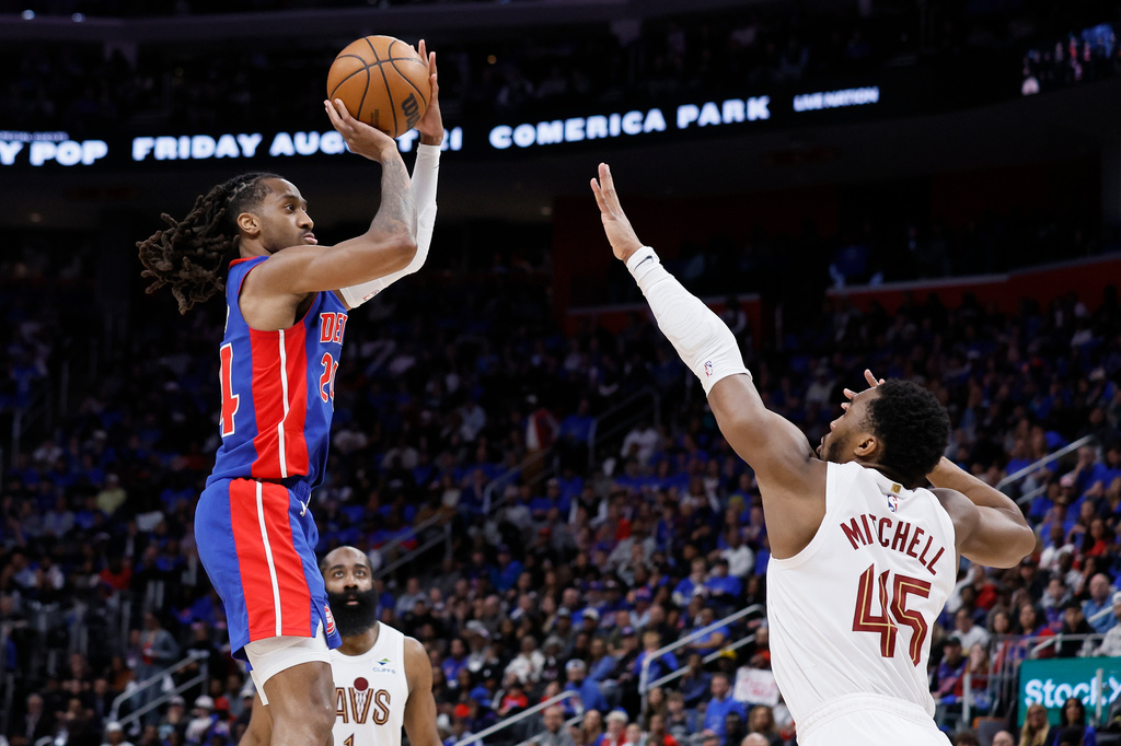 Detroit Pistons guard Daniss Jenkins, left, takes a jump shot against Cleveland Cavaliers guard Donovan Mitchell (45) during the first half in Game 5 of a second-round NBA playoffs basketball series Wednesday, May 13, 2026, in Detroit. (AP Photo/Duane Burleson)