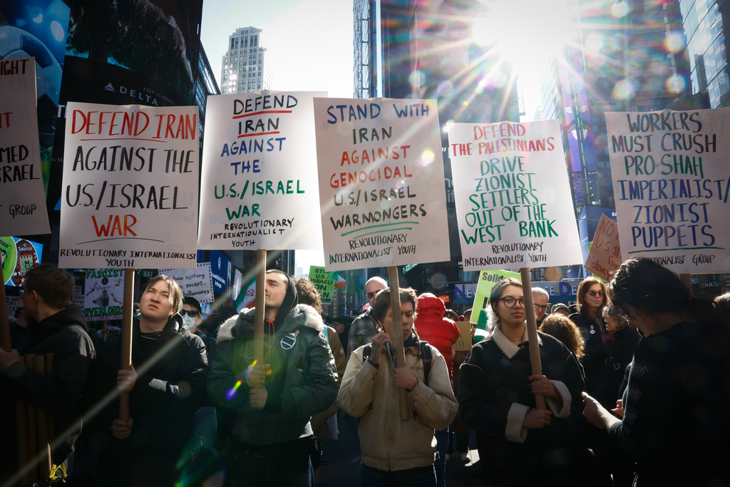 People protest against U.S. and Israeli strikes on Iran, in New York, Saturday, Feb. 28, 2026. (AP Photo/Kena Betancur)
