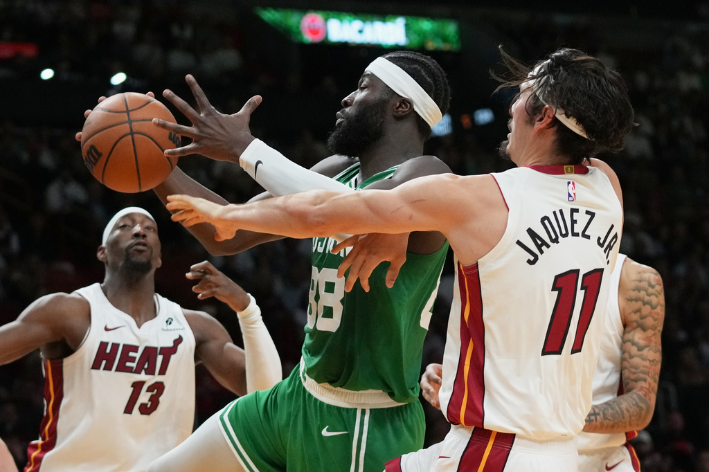 Miami Heat forward Jaime Jaquez Jr. (11) defends Boston Celtics center Neemias Queta (88) during the first half of an NBA basketball game, Wednesday, April 1, 2026, in Miami. (AP Photo/Lynne Sladky)