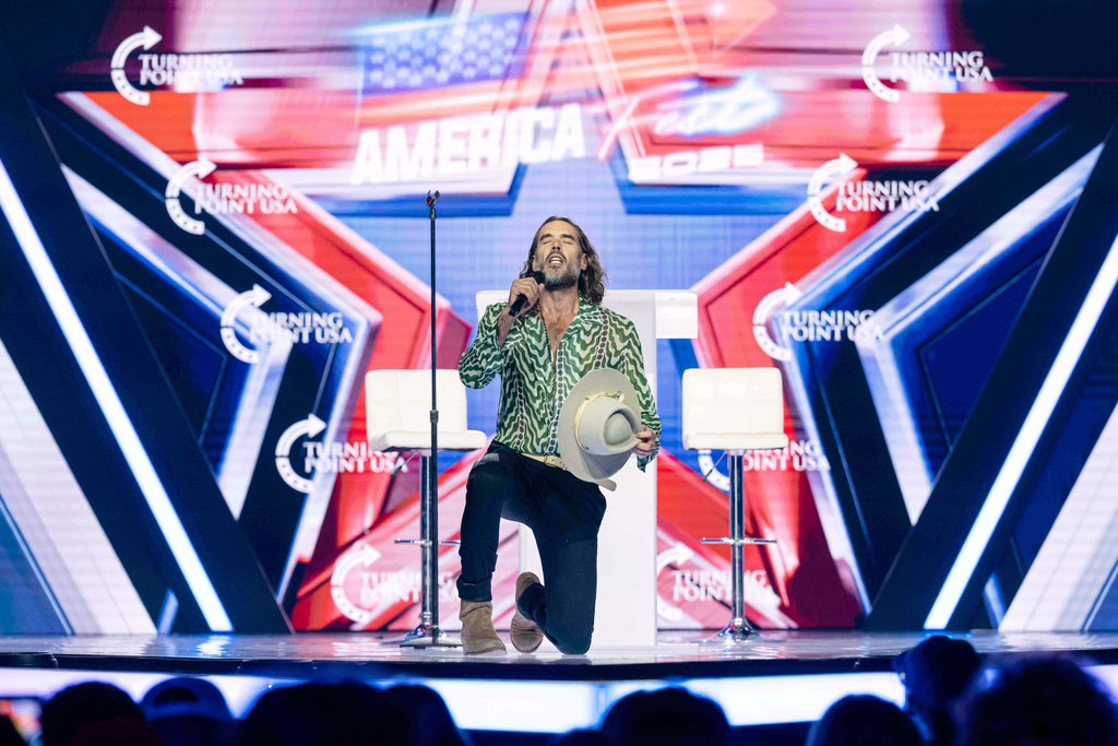 Russell Brand speaks during Turning Point USA's AmericaFest 2025, Thursday, Dec. 18, 2025, in Phoenix. (AP Photo/Jon Cherry)